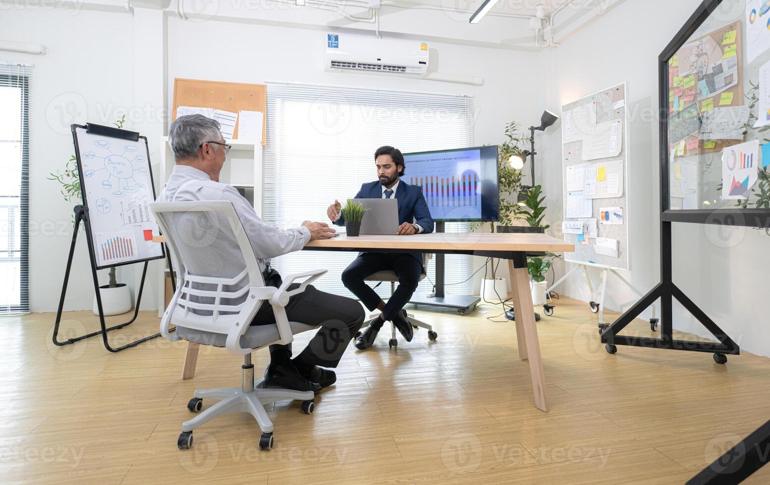 In a contemporary office, two senior executives with a mission to brainstorm and monitor,76 photo