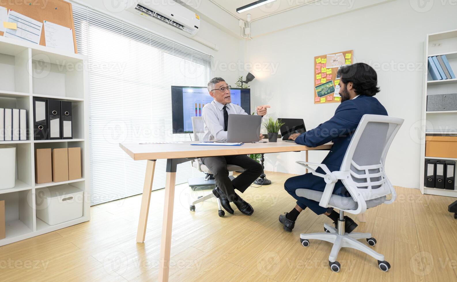 In a contemporary office, two senior executives with a mission to brainstorm and monitor,74 photo