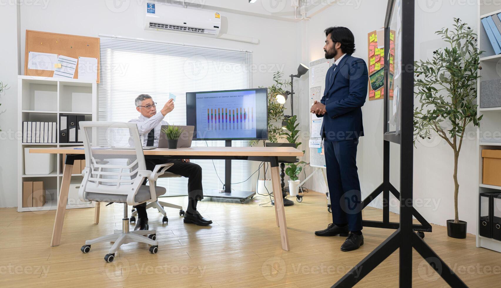 In a contemporary office, two senior executives with a mission to brainstorm and monitor,72 photo