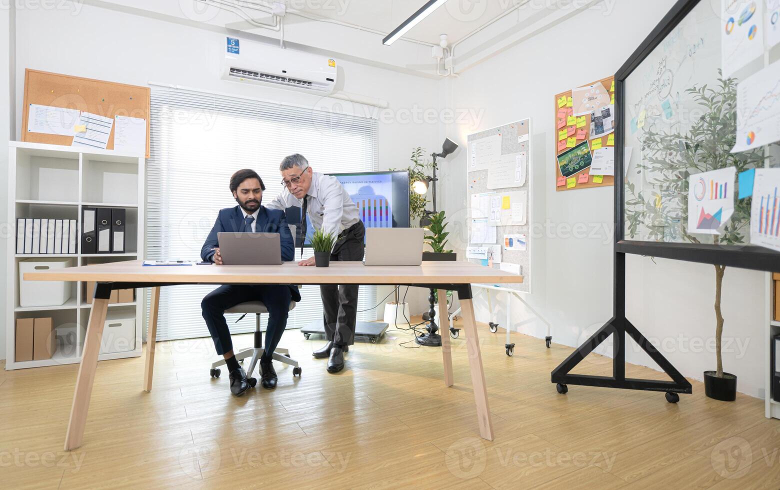 In a contemporary office, two senior executives with a mission to brainstorm and monitor,75 photo