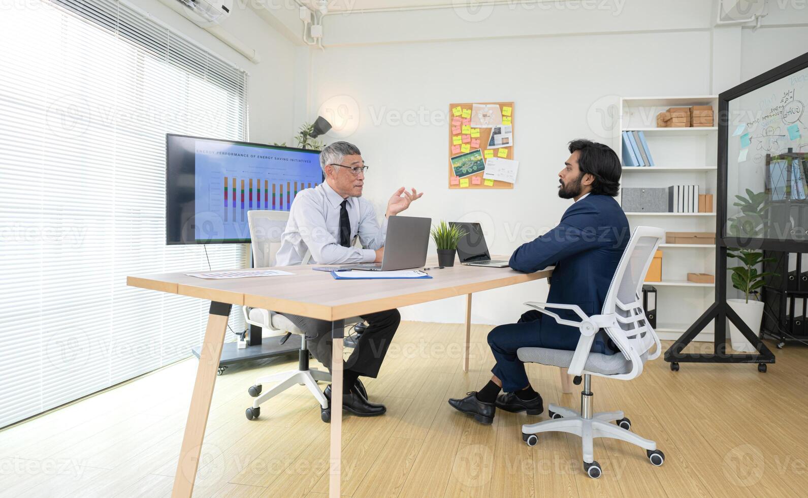In a contemporary office, two senior executives with a mission to brainstorm and monitor,60 photo