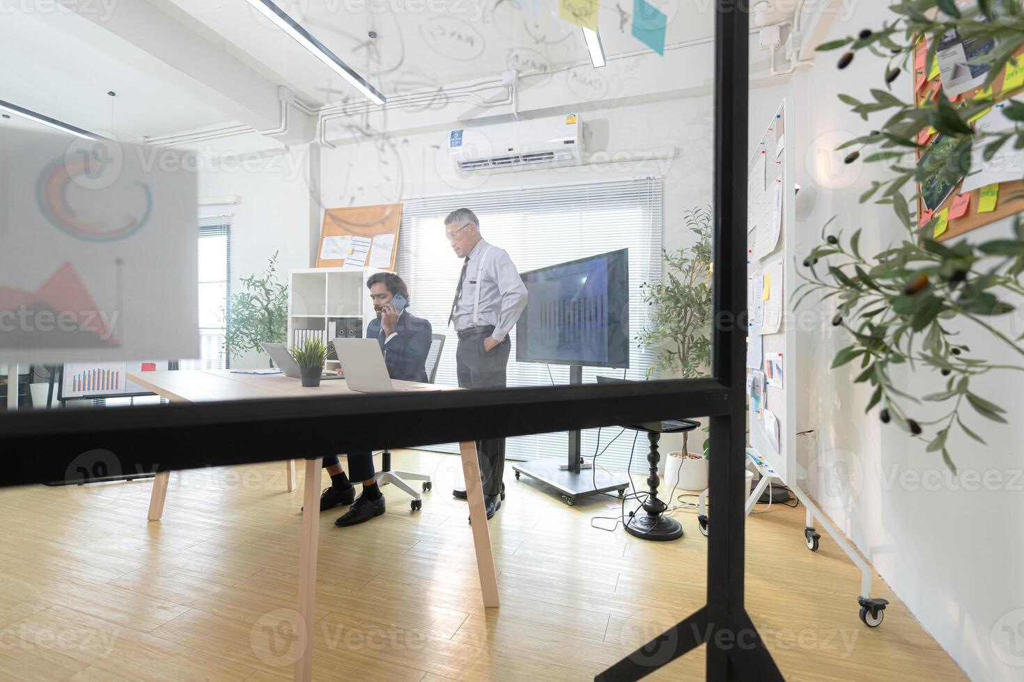 In a contemporary office, two senior executives with a mission to brainstorm and monitor,59 photo