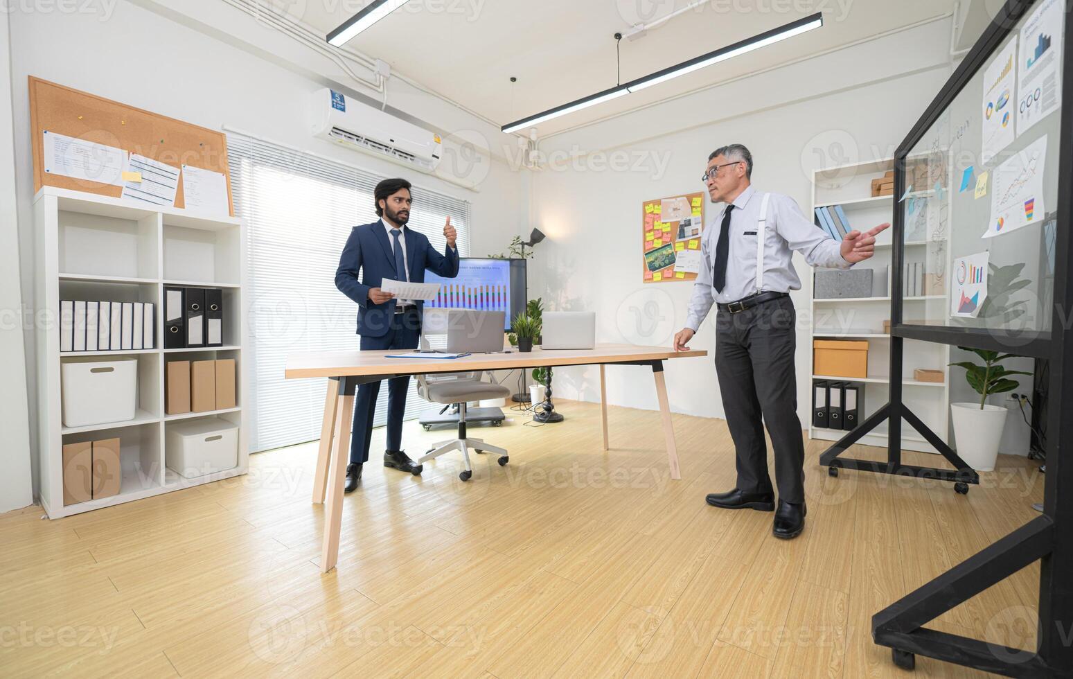 In a contemporary office, two senior executives with a mission to brainstorm and monitor,56 photo