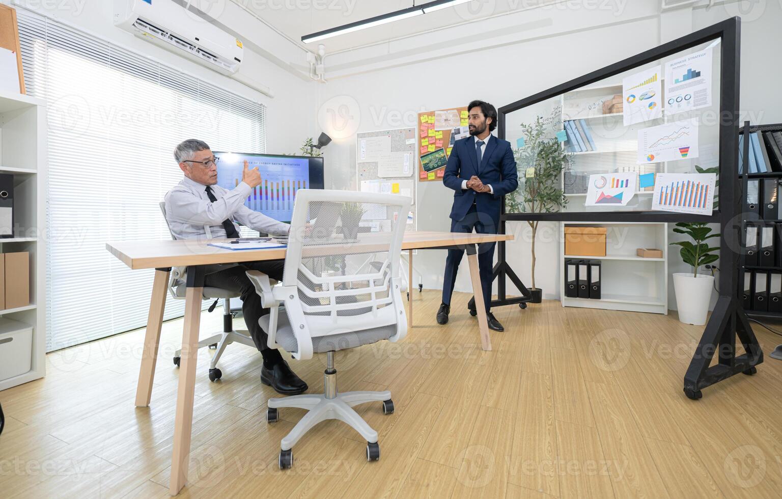 In a contemporary office, two senior executives with a mission to brainstorm and monitor,50 photo