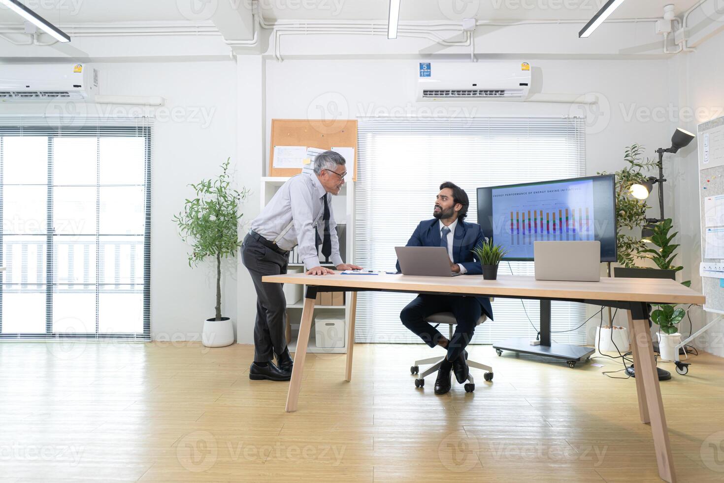 In a contemporary office, two senior executives with a mission to brainstorm and monitor,37 photo