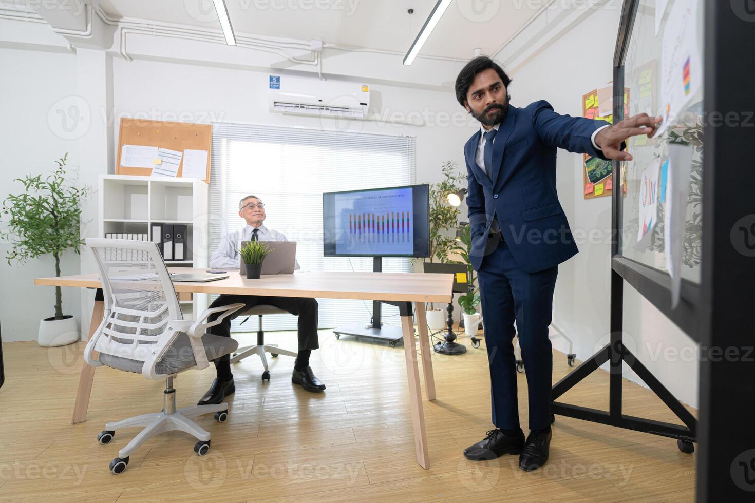 In a contemporary office, two senior executives with a mission to brainstorm and monitor,32 photo