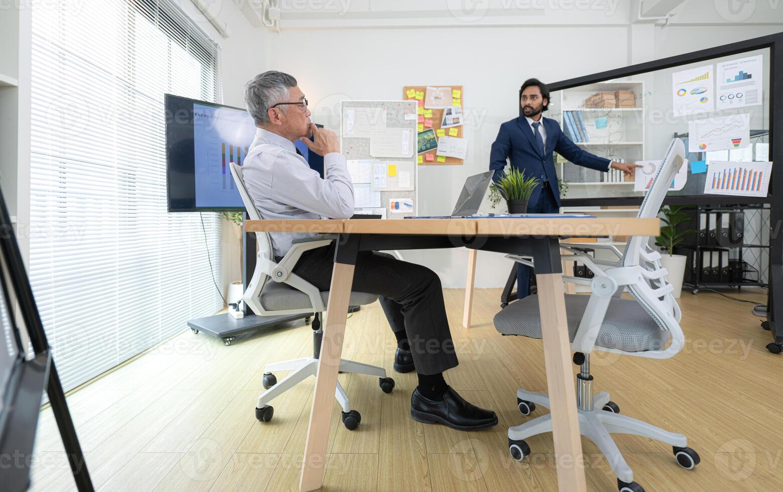 In a contemporary office, two senior executives with a mission to brainstorm and monitor,14 photo