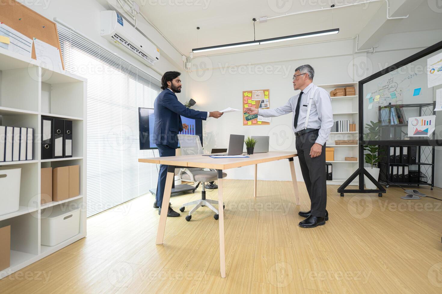In a contemporary office, two senior executives with a mission to brainstorm and monitor,13 photo