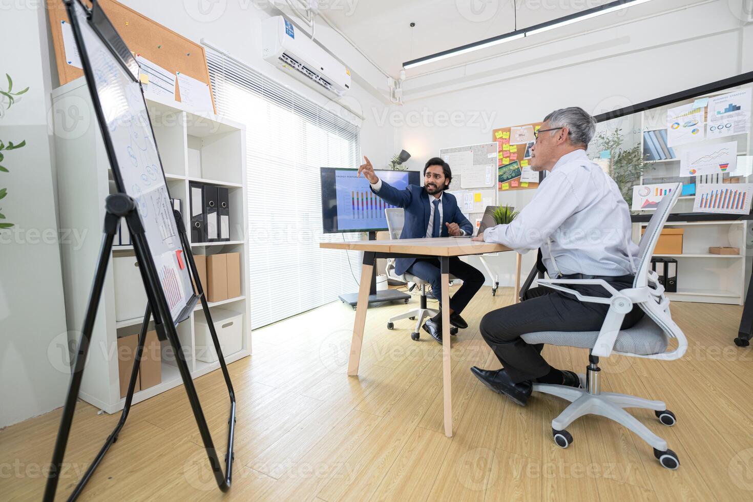 In a contemporary office, two senior executives with a mission to brainstorm and monitor,12 photo