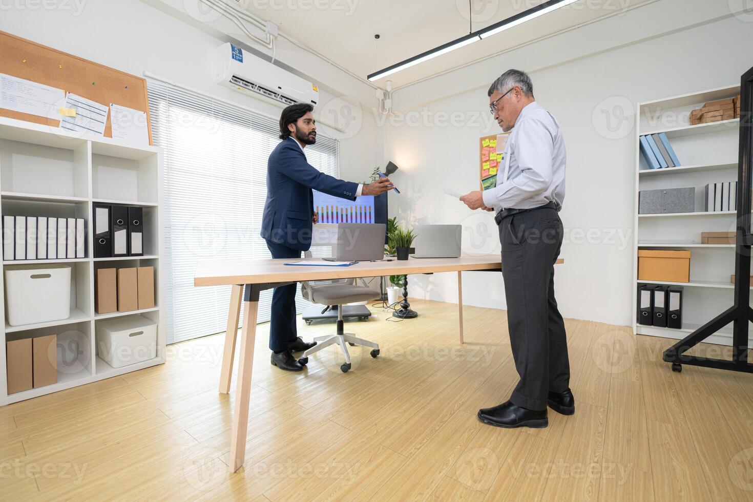 In a contemporary office, two senior executives with a mission to brainstorm and monitor,7 photo