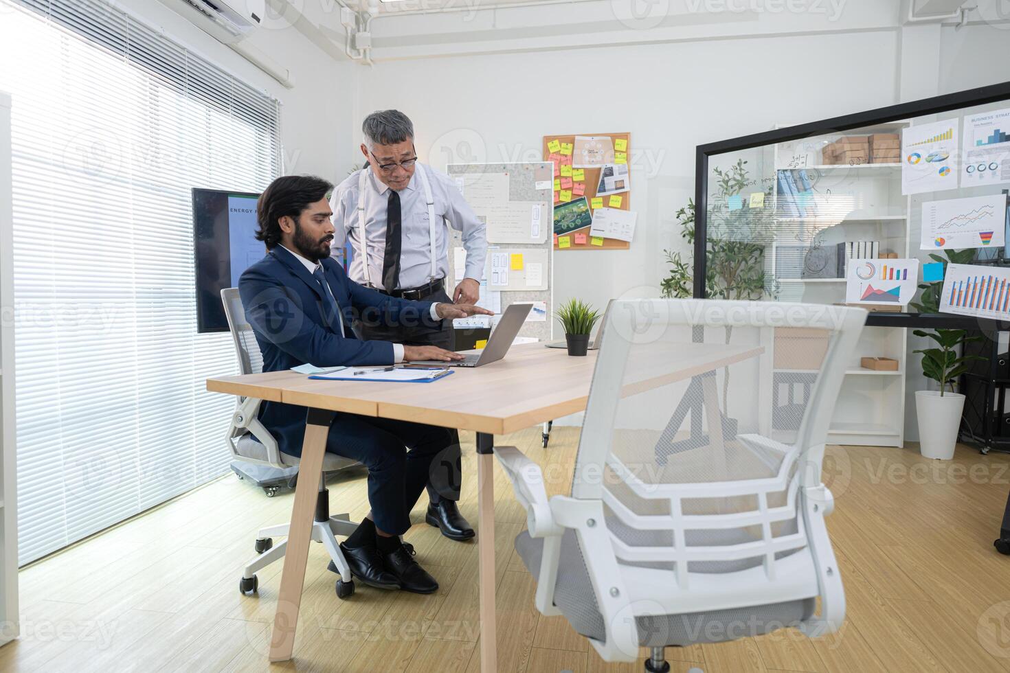 In a contemporary office, two senior executives with a mission to brainstorm and monitor,3 photo