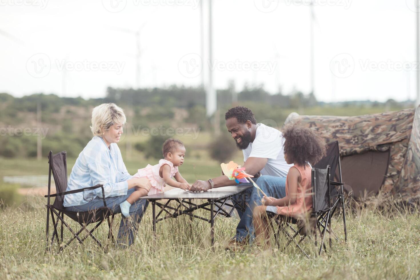 Family picnic camping in the wind turbine field,13 photo