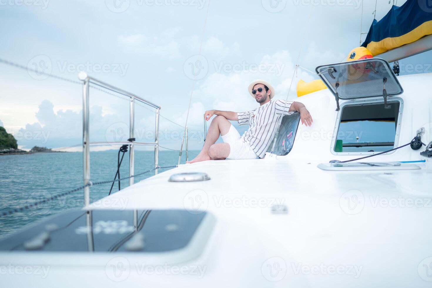 A young man is enjoying his seaside adventure aboard a yacht,127 photo
