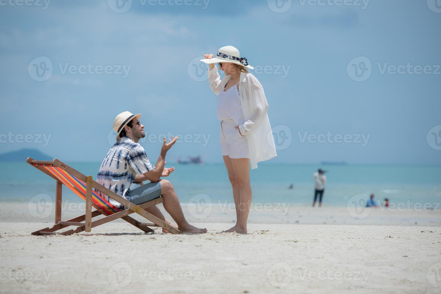 Young couple on vacation on a white sandy beach, clear sky and sea,120 photo