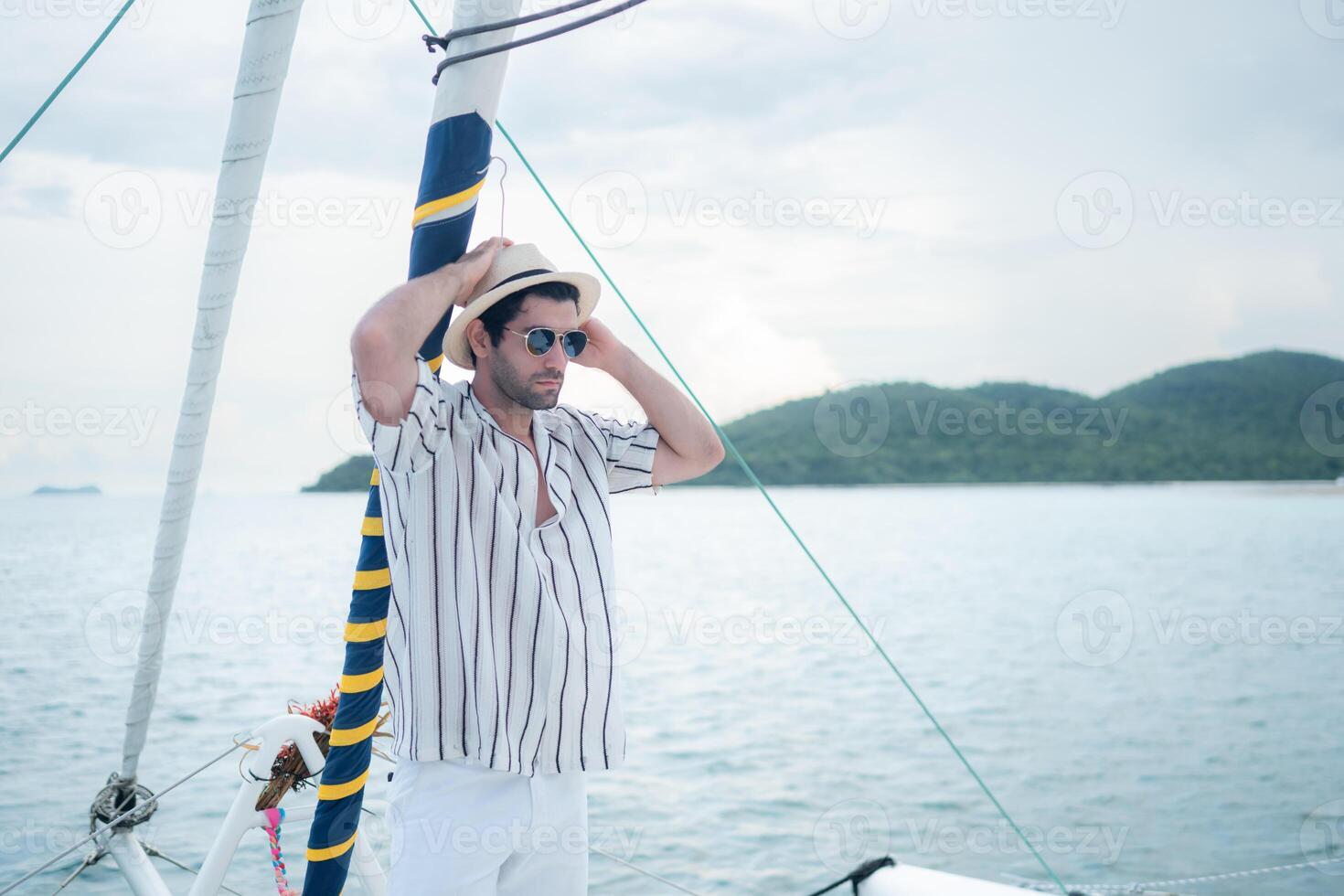 A young man is enjoying his seaside adventure aboard a yacht,119 photo
