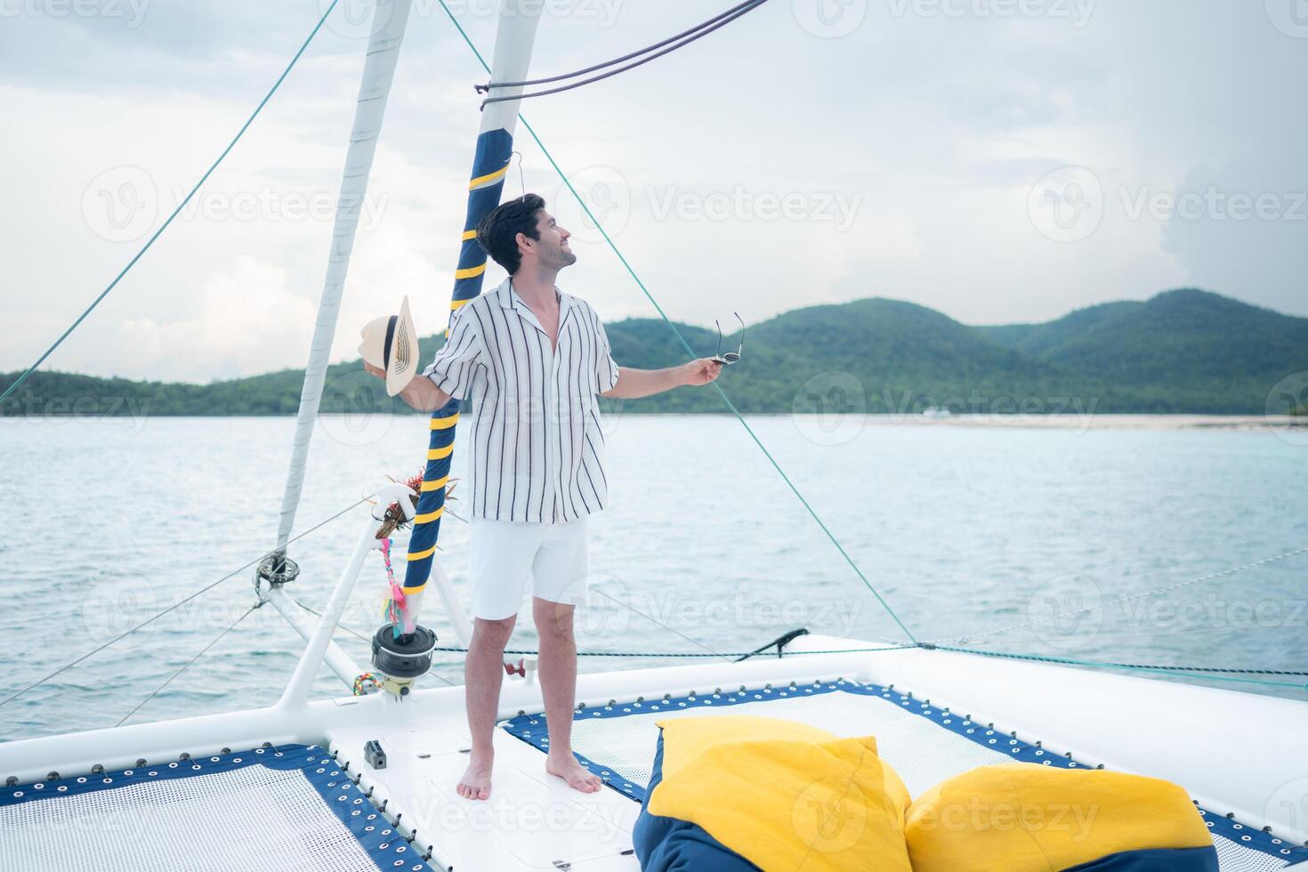 A young man is enjoying his seaside adventure aboard a yacht,81 photo