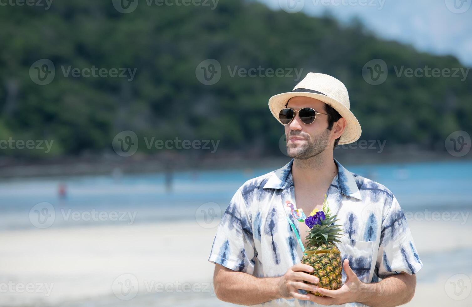 Young man on vacation on a white sandy beach, clear sky and sea,61 photo