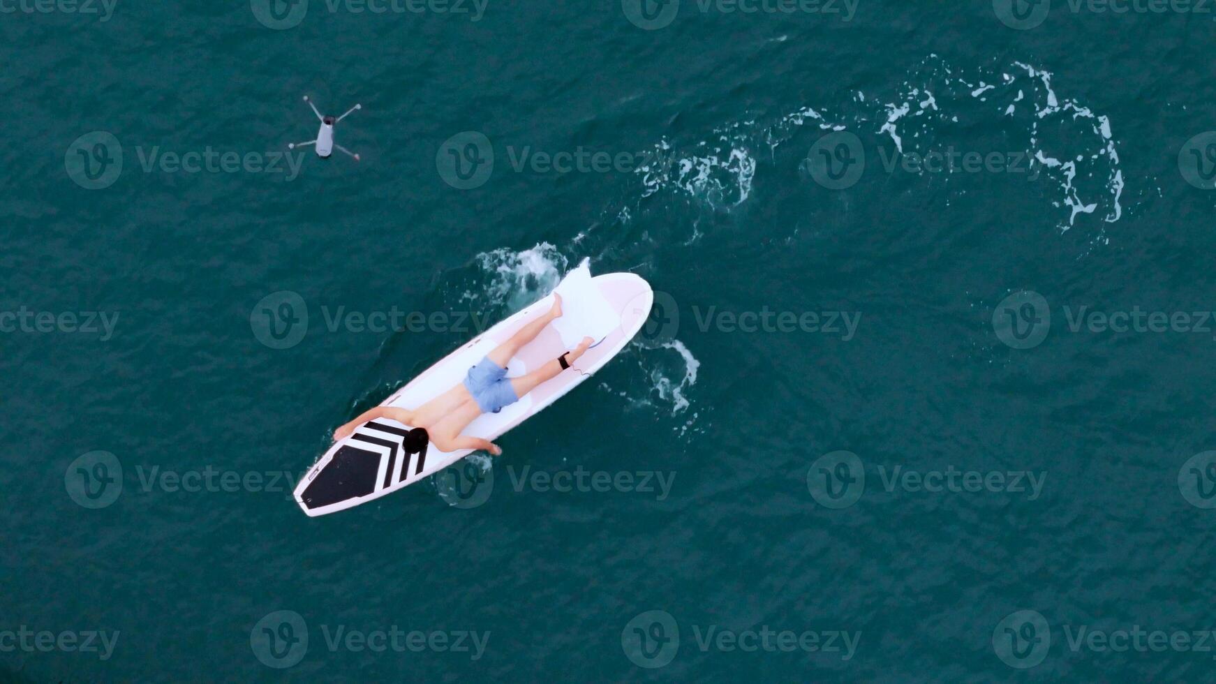 A young man is enjoying his ocean adventure aboard a yacht and surfboard,14 photo