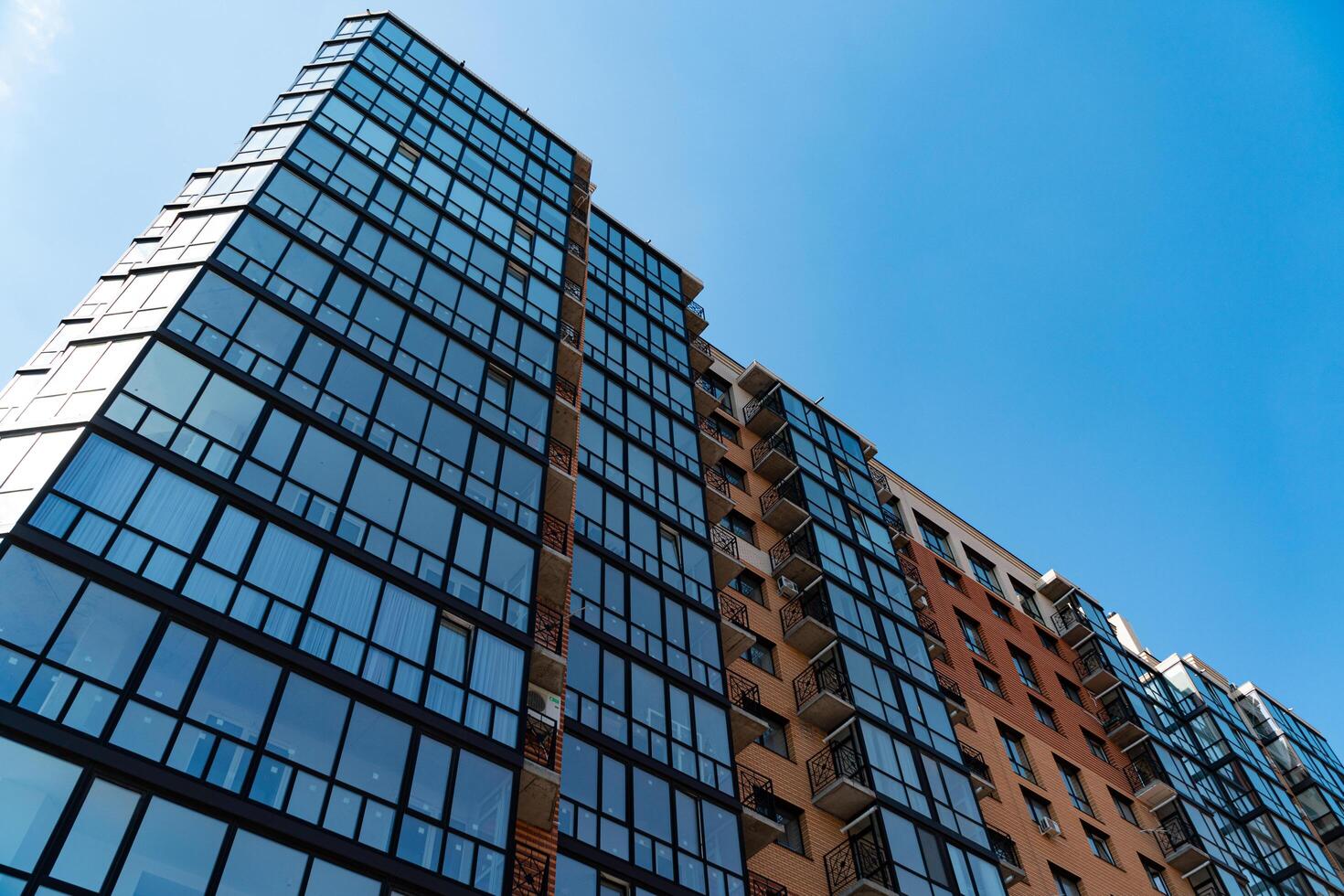 Apartment residential house and home facade. Fragment of a new elite residential building. Blue sky on the background photo