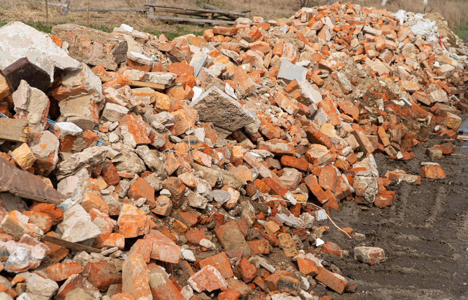 Pile of broken red bricks. Building bricks. Construction debris photo