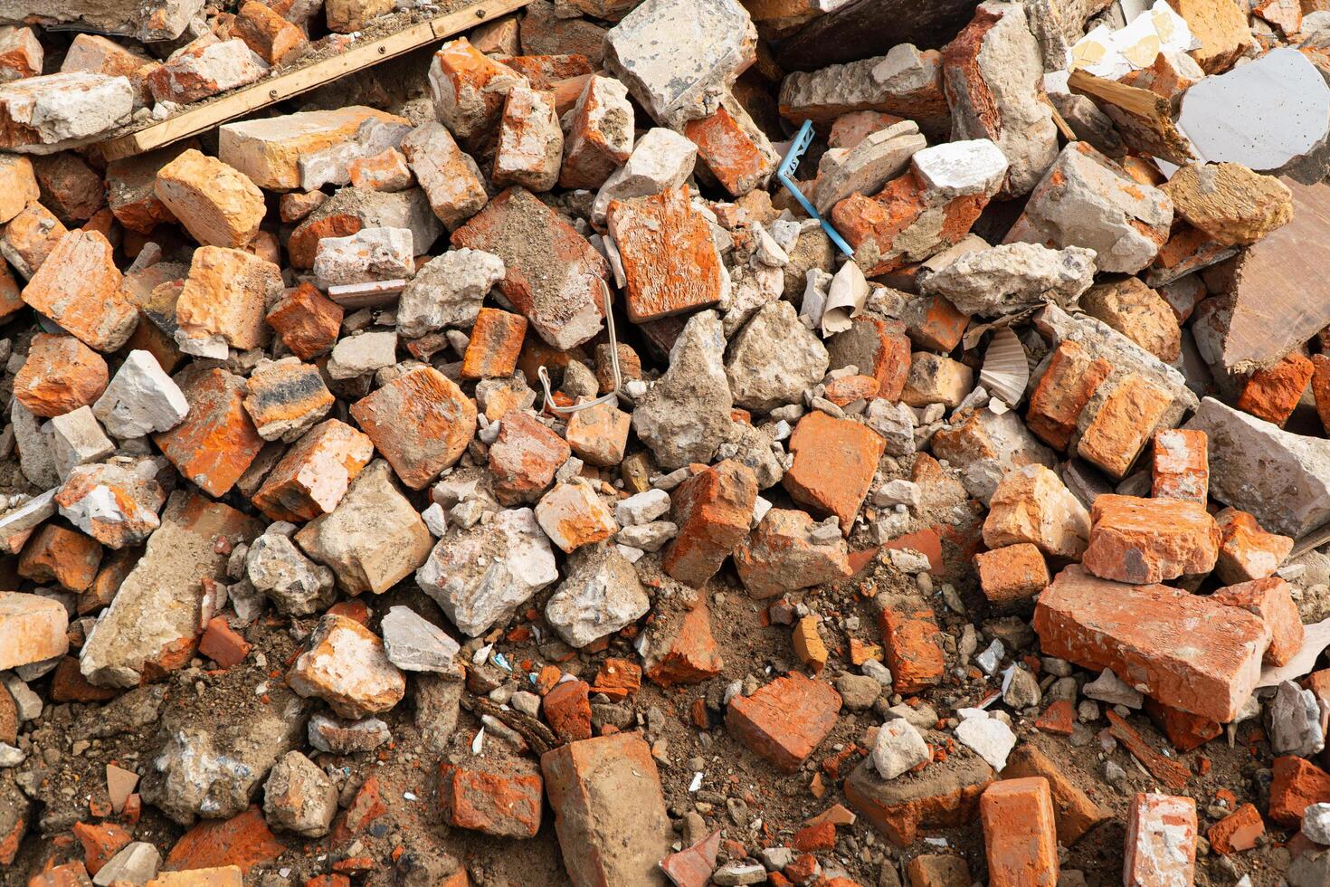 A pile of broken red bricks. Broken bricks close up. Construction debris photo