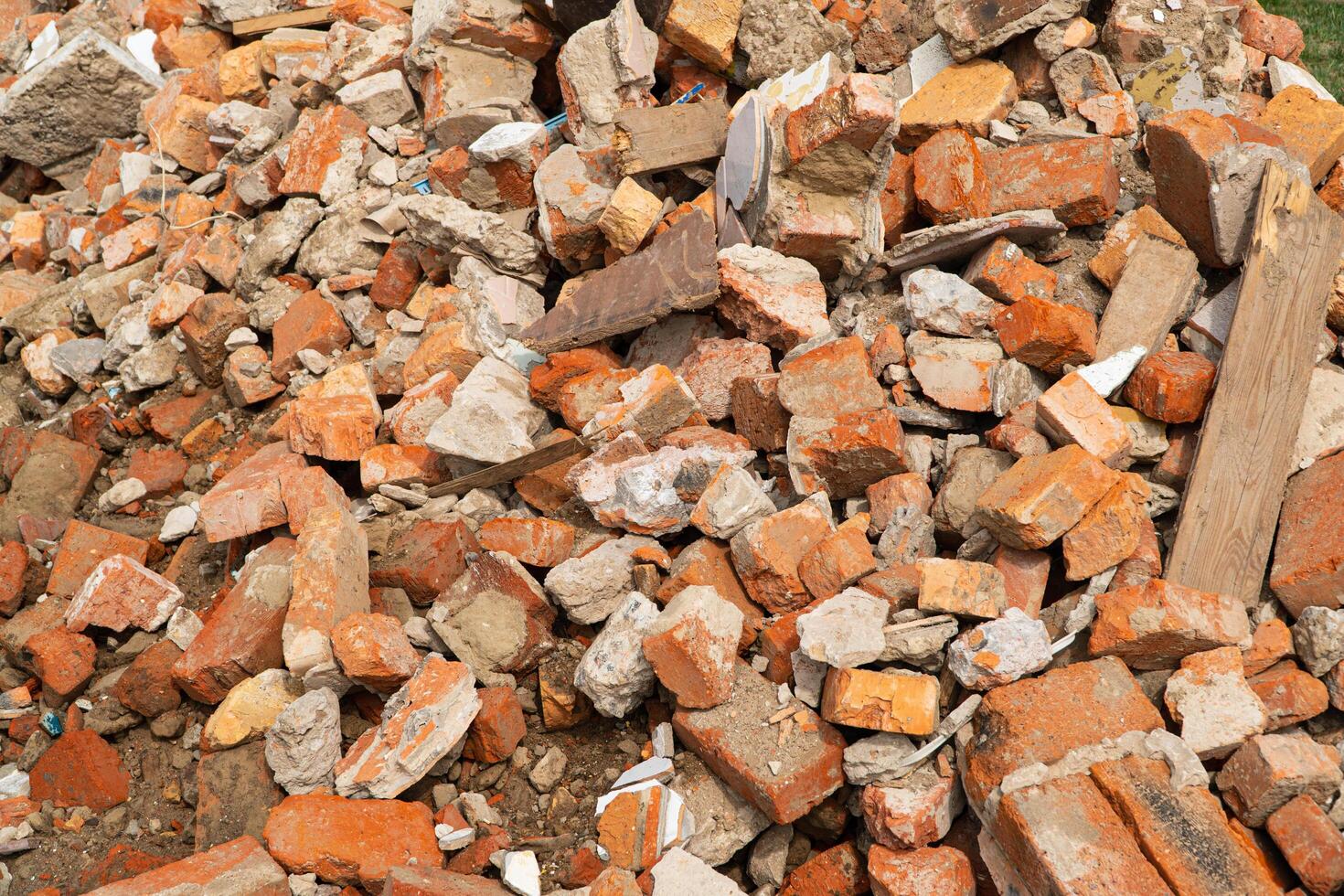A pile of broken red bricks and fragments of concrete. Construction debris photo