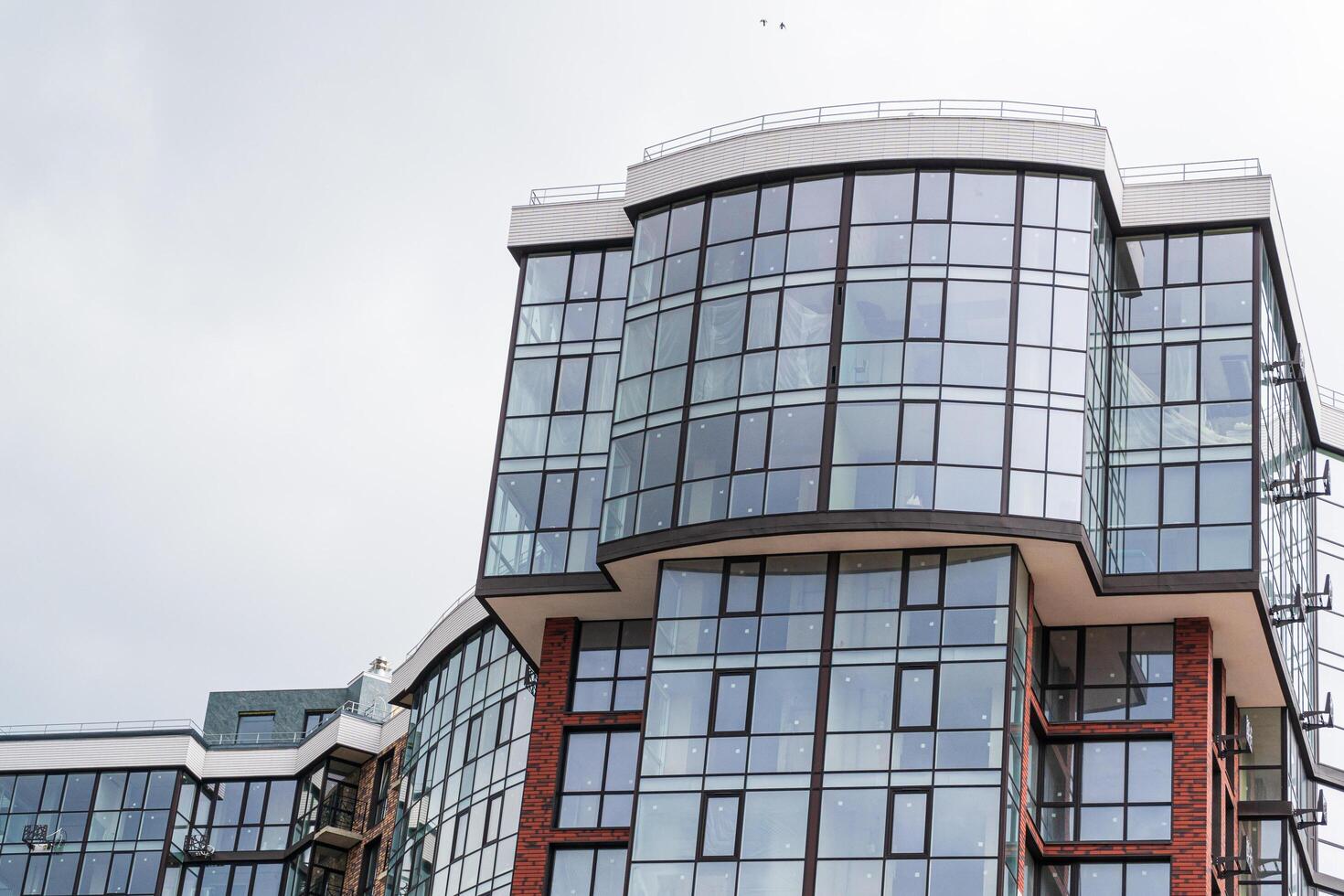Modern apartment building. Multi Storey modern, new and stylish living block of flats. Fragment of a new elite residential building or commercial complex photo