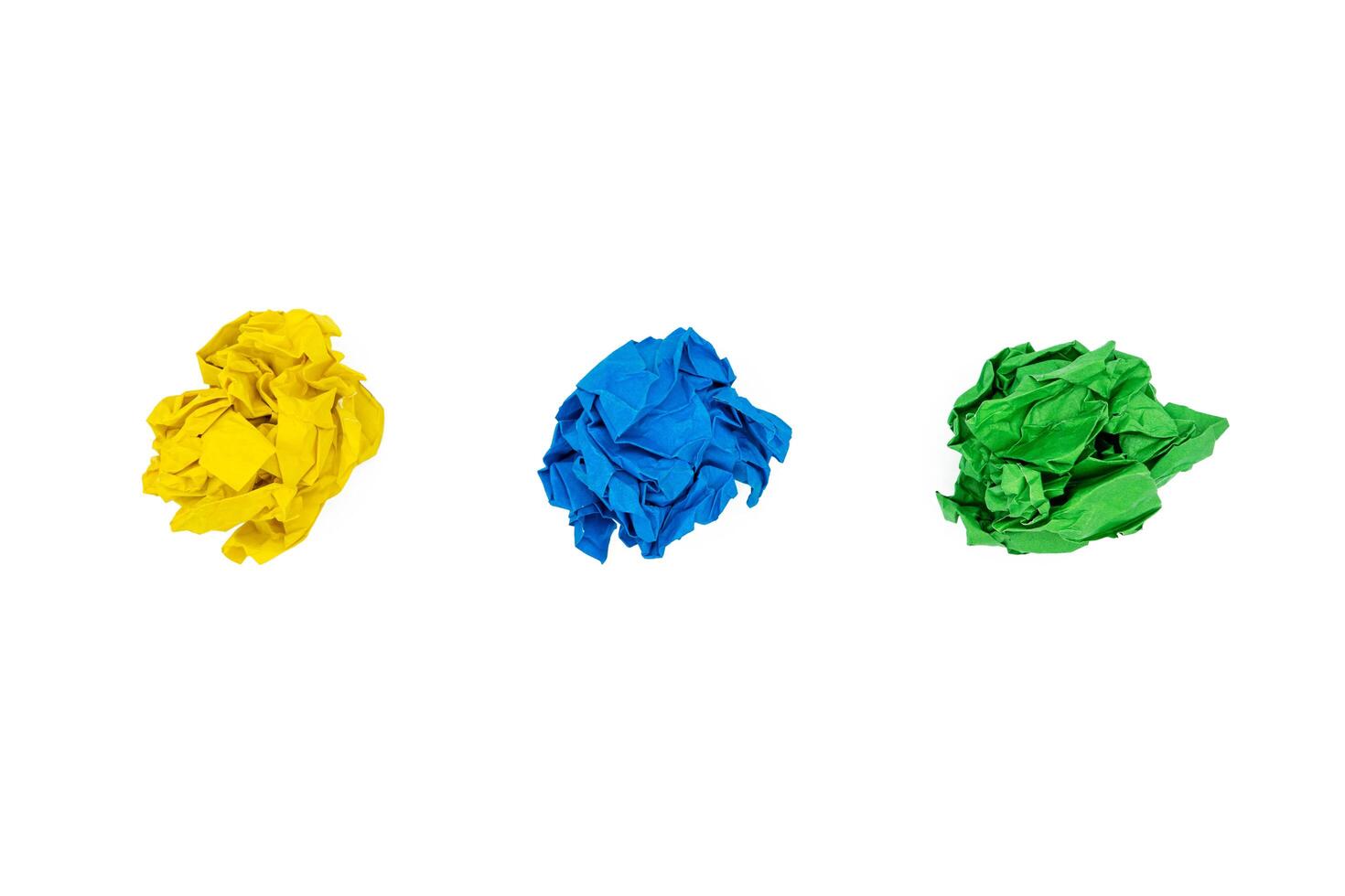 Collection of colorful crumpled papers solated on white background. Yellow, blue and green photo