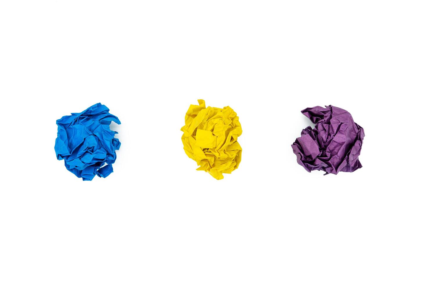 Set of multi-colored paper balls isolated on white background. Blue, yellow and purple photo