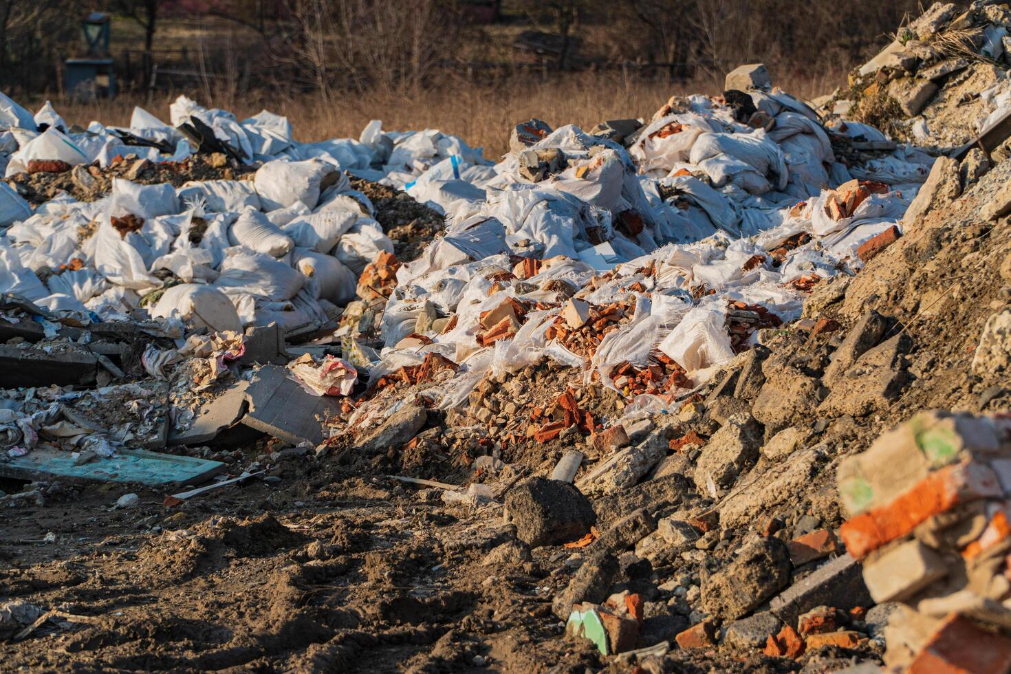 Large construction bags filled with construction debris. A pile of old construction waste. Environmental pollution from construction waste photo