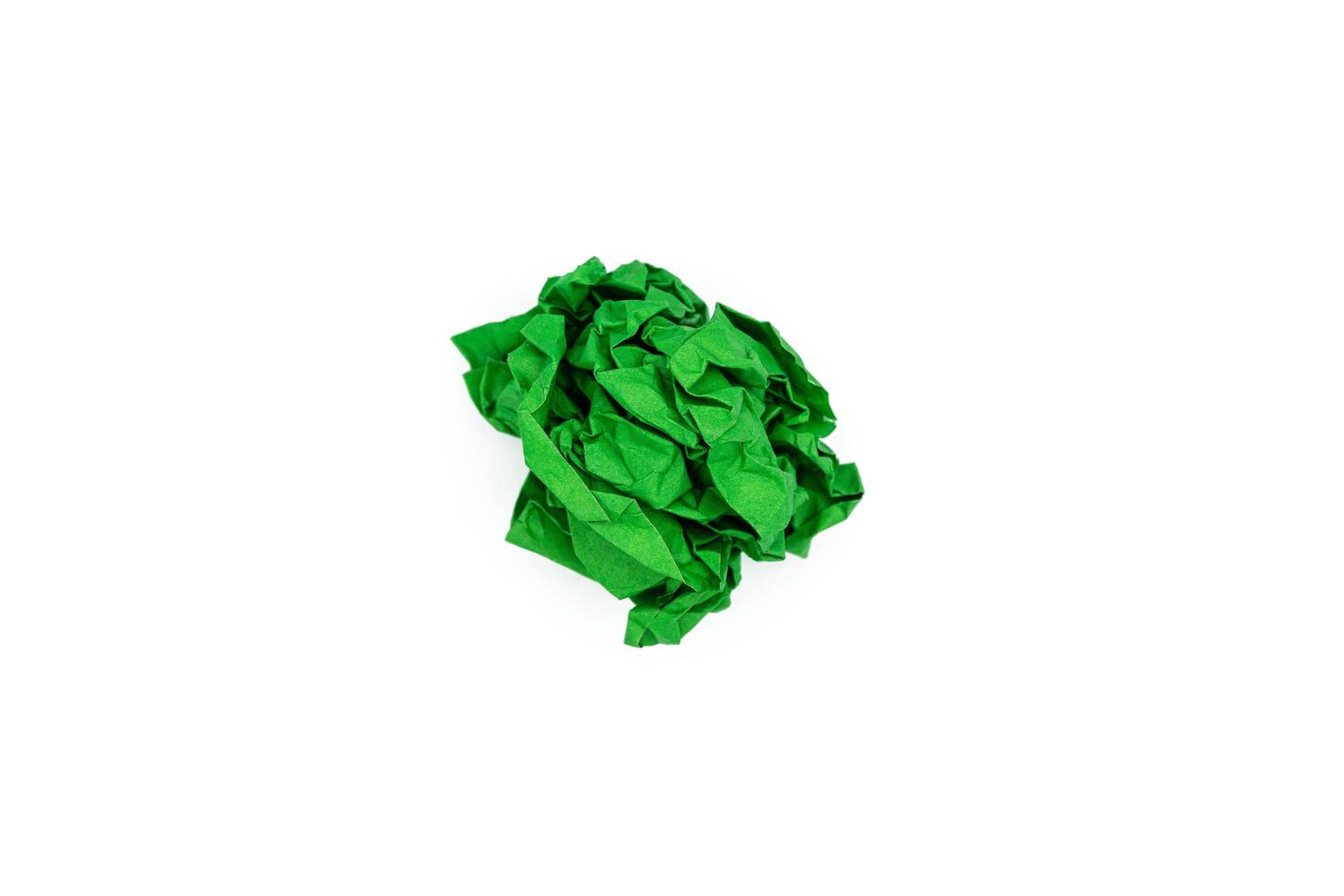 Green crumpled paper ball isolated on white. Blank for the designer photo