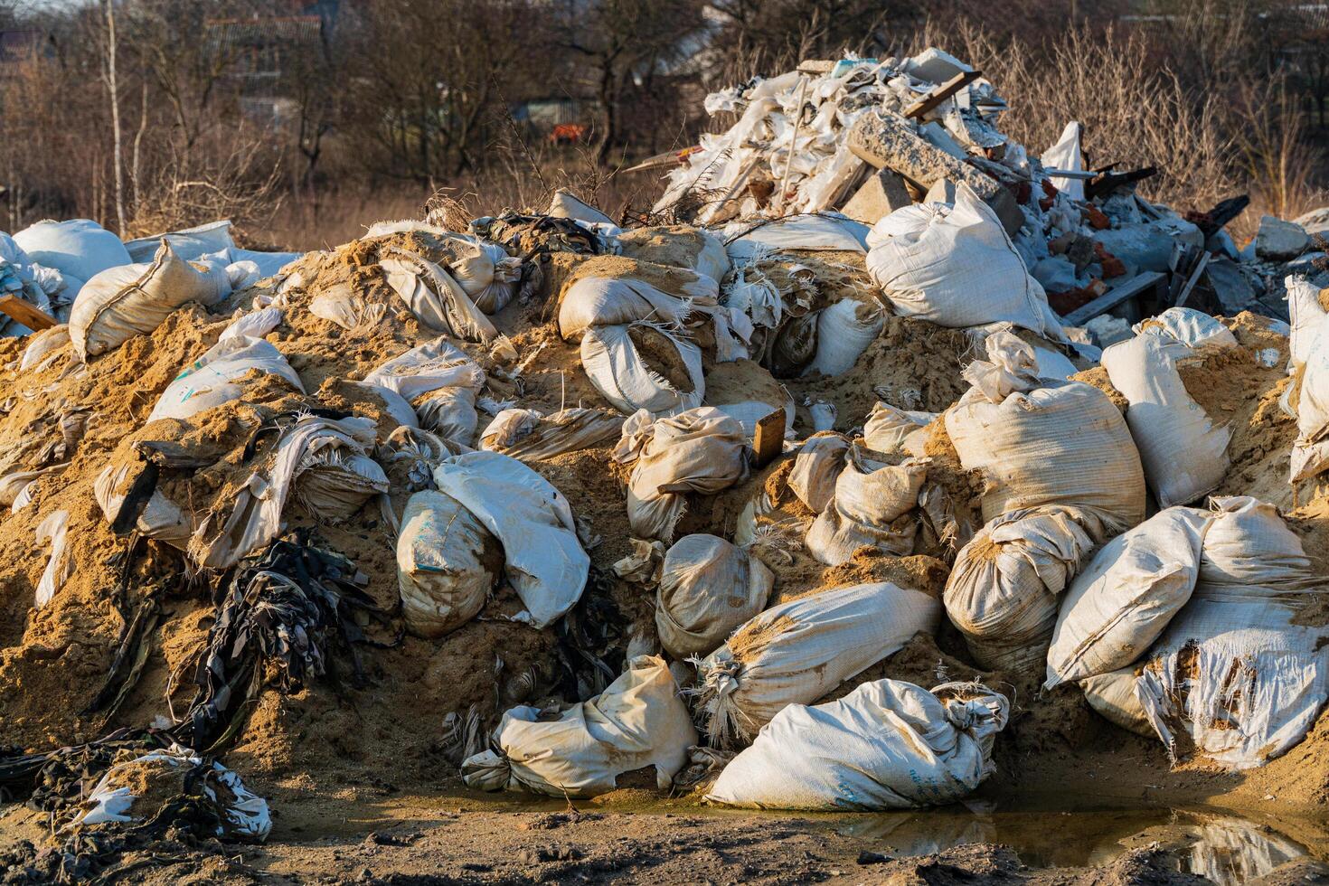 A large pile of construction debris at a landfill. Dump of various waste. Illegal dump. Negative impact on nature. Waste dump concept photo