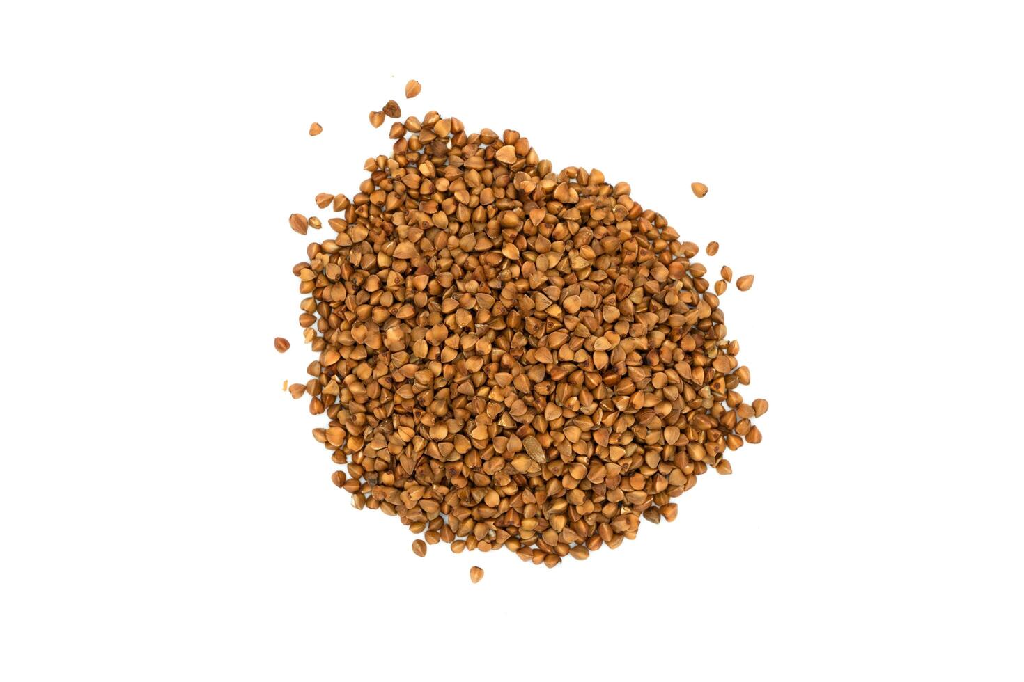 A bunch of buckwheat on a white background. Buckwheat grains. Top view photo