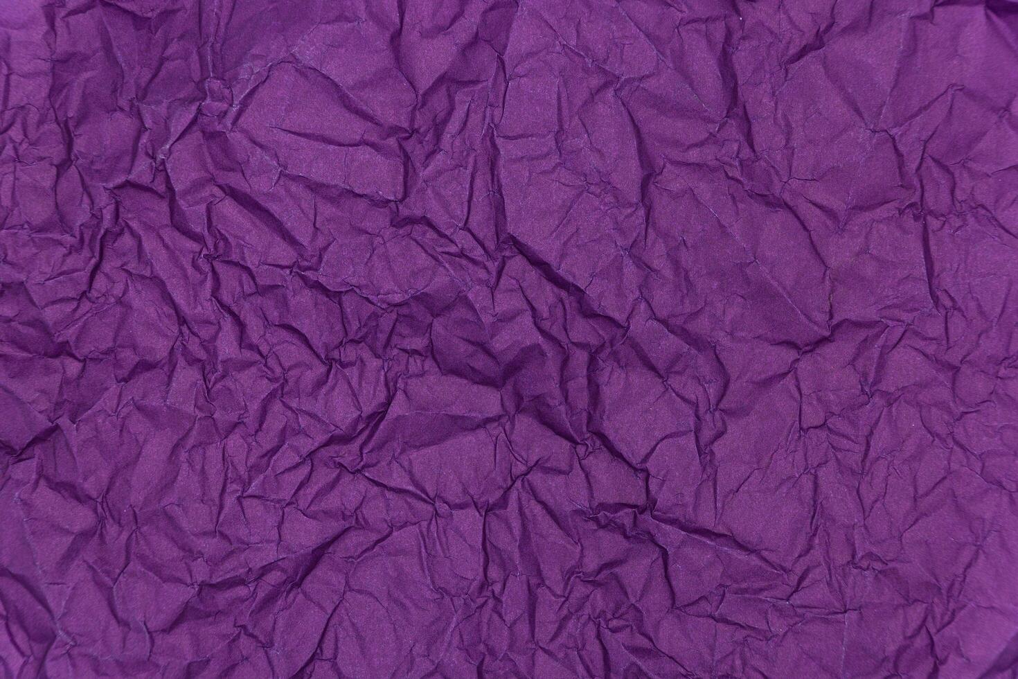 Purple crumpled paper background. Texture of crumpled paper photo