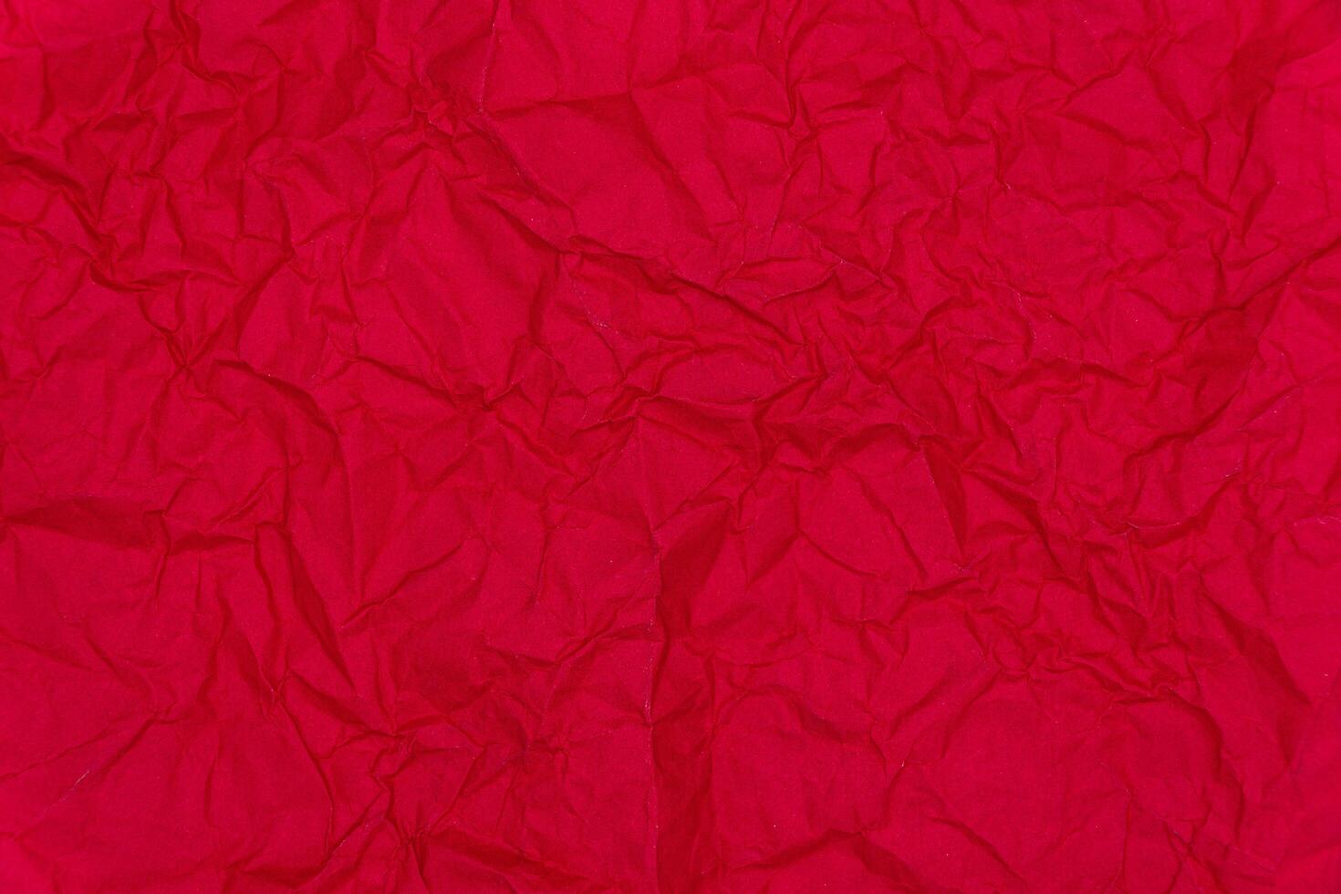Red crumpled paper background. Crumpled red paper texture photo