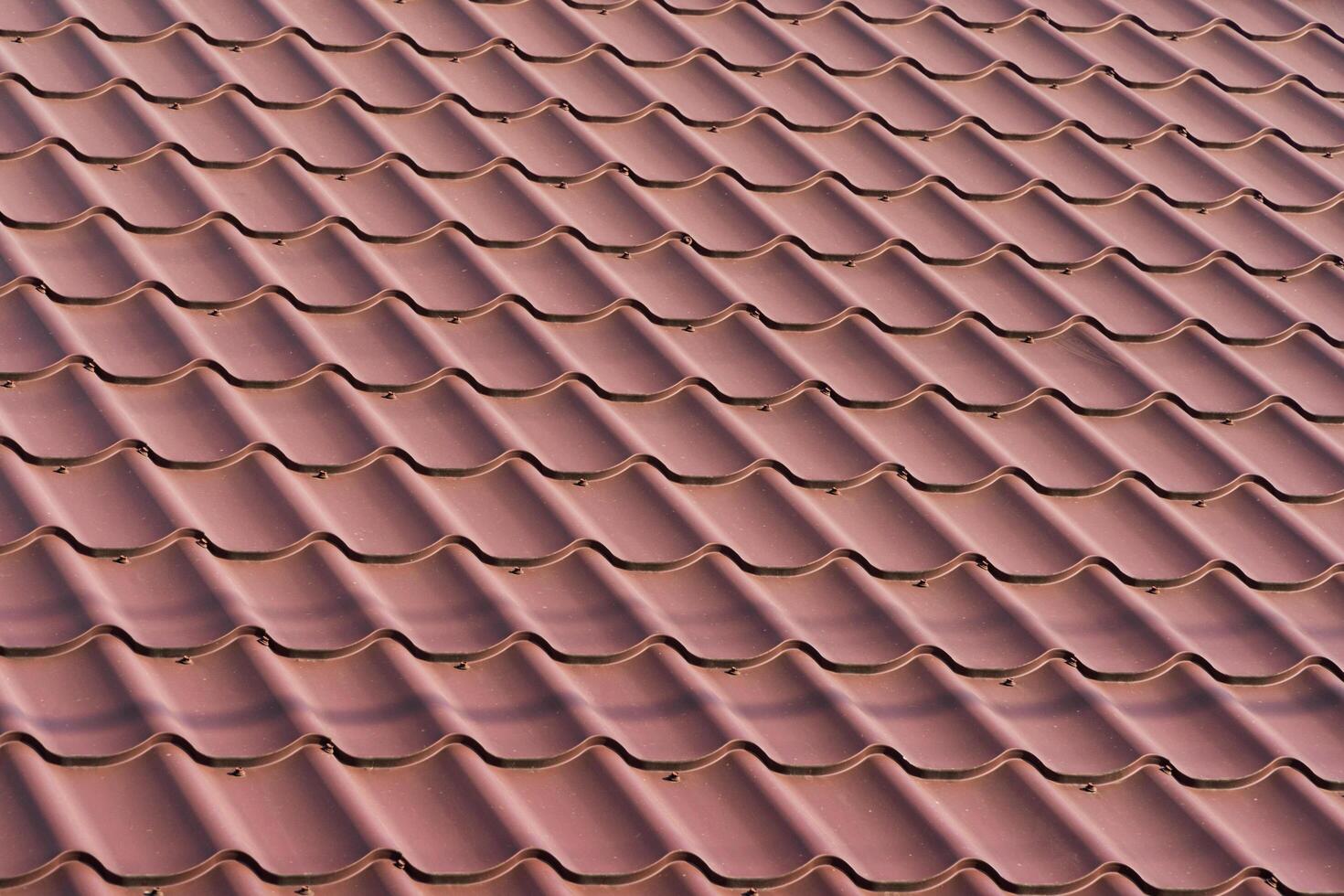Red metal roof tiles. Metal tile photo