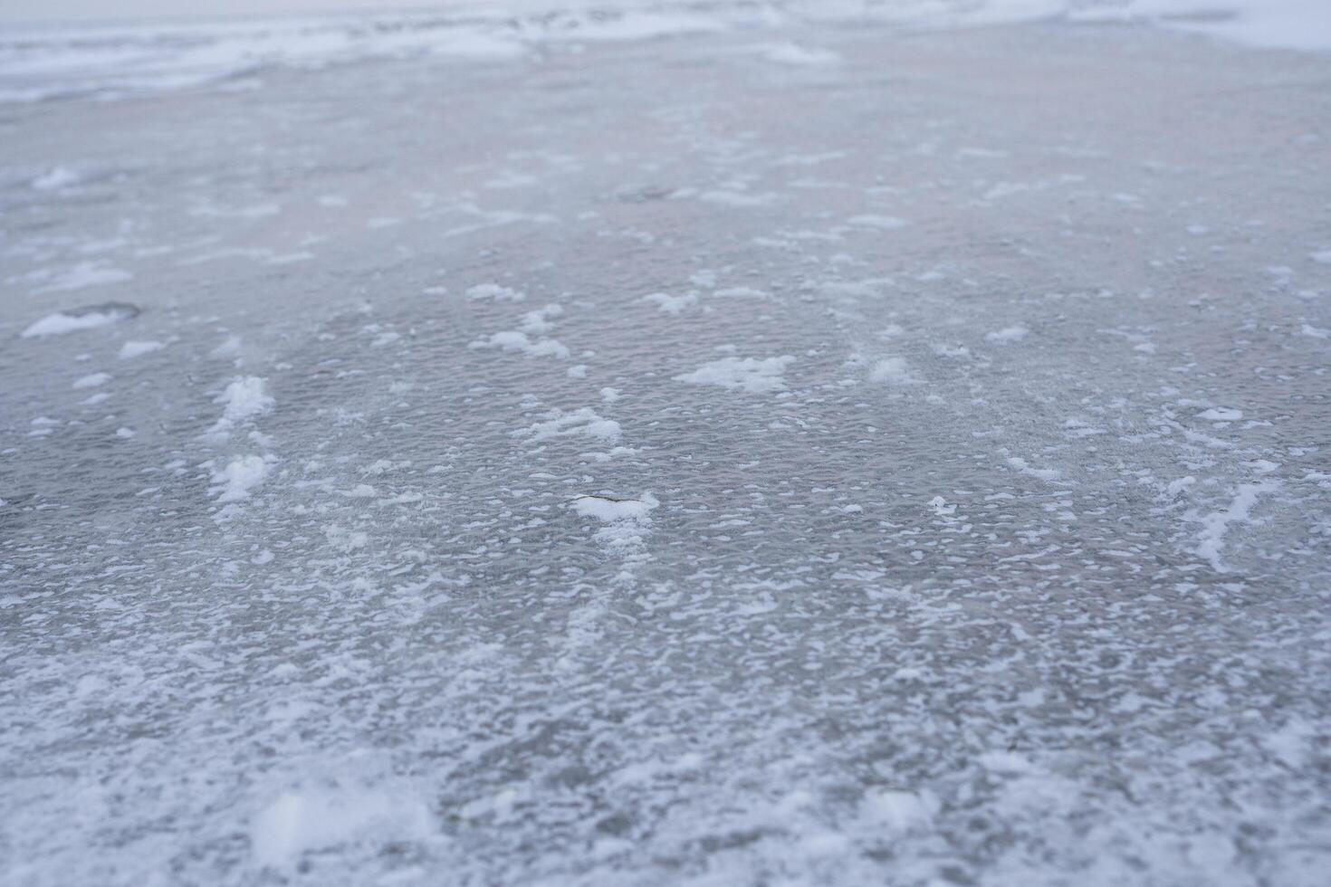 The ice is covered with snow. photo