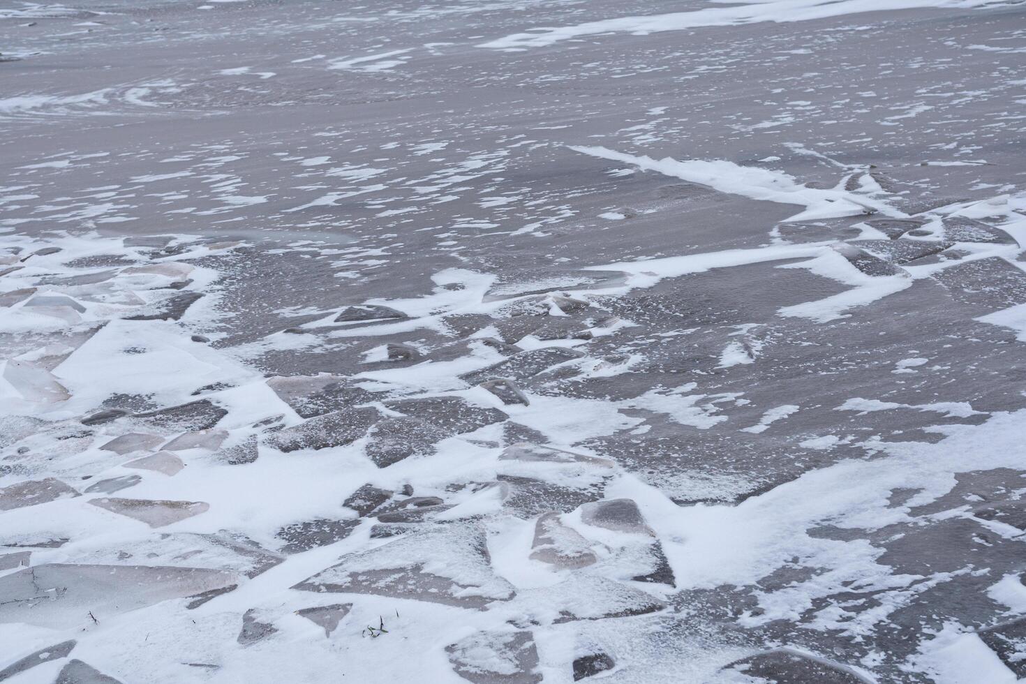 Cracks in the ice of the lake. Ice background texture. photo
