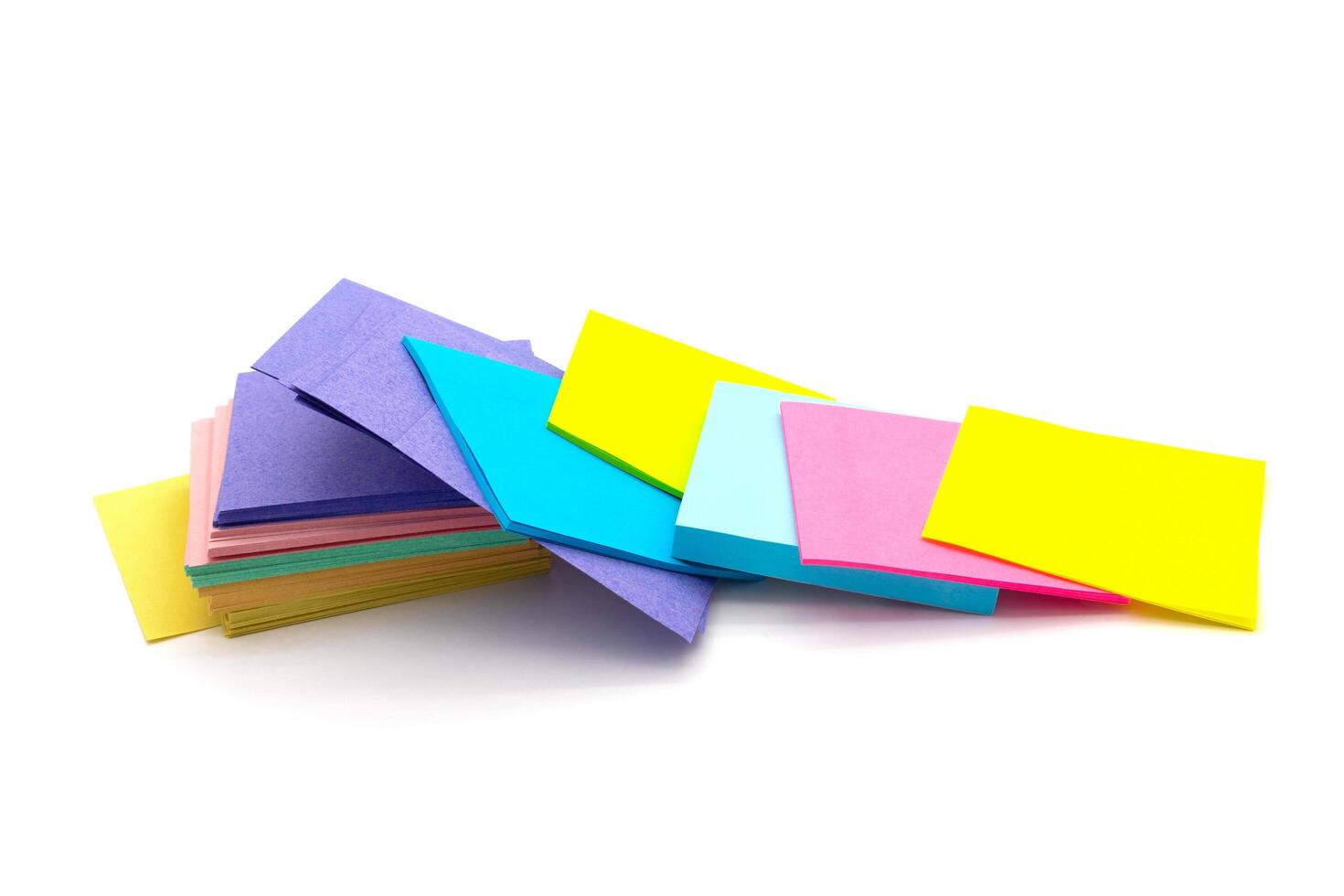 Color block of paper notes isolated on white photo