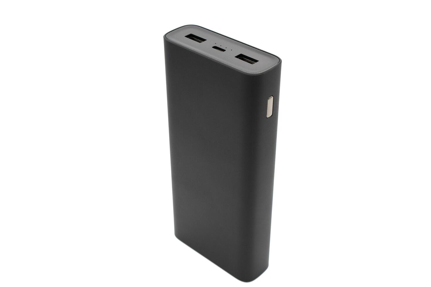Black power bank on white background. External battery for recharging photo