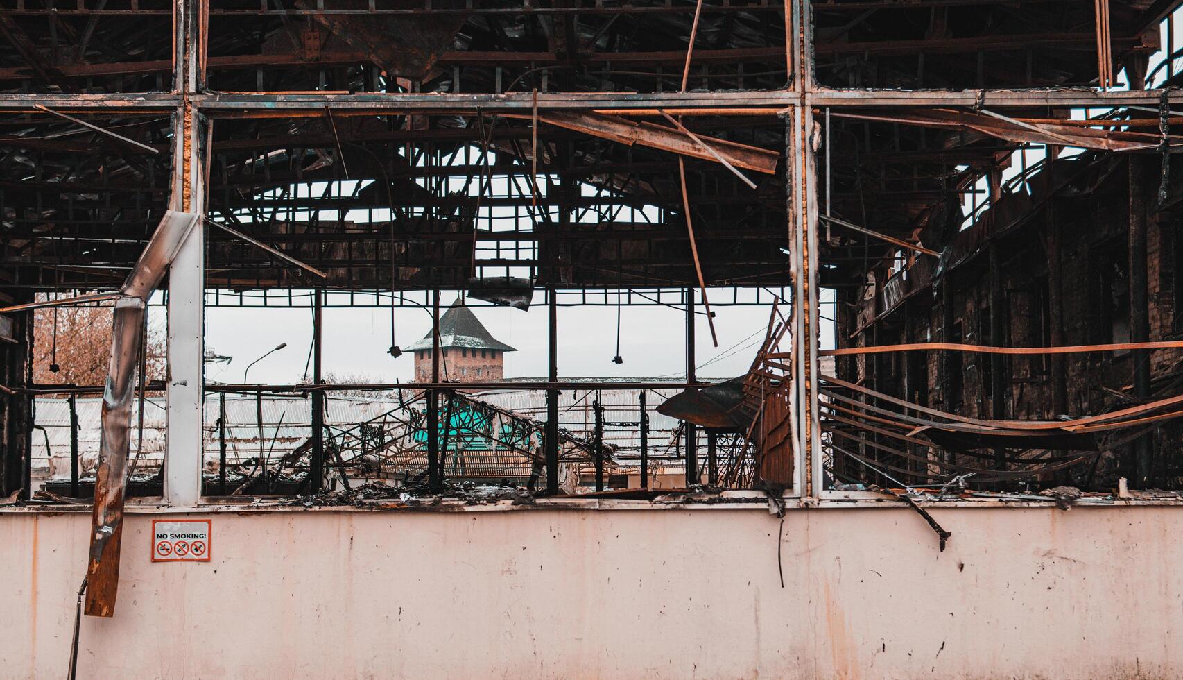 Damage to a commercial building following a structure fire. Windows broken after fire disaster, destroyed property photo