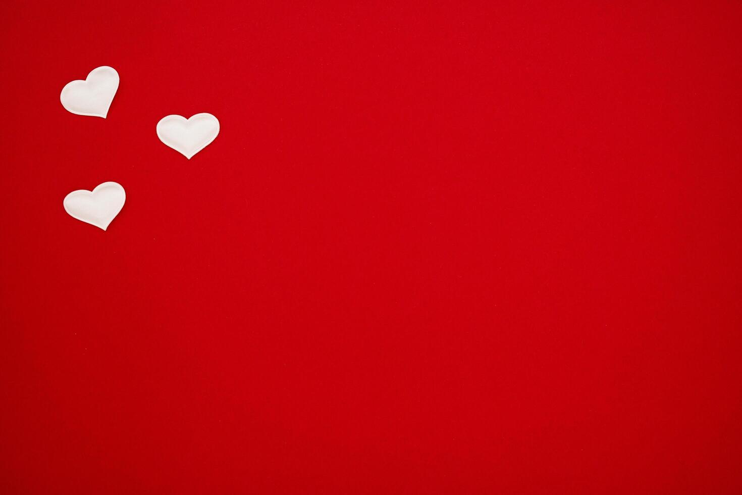 Three small hearts on a red background. Banner, flyer, beautiful postcard. Birthday, Wedding, Valentine's Day, March 8 photo