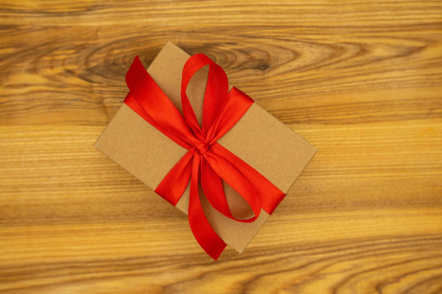 Close up gift on wooden background, valentine day, birthday, mother's day. Place for text, banner, top view photo