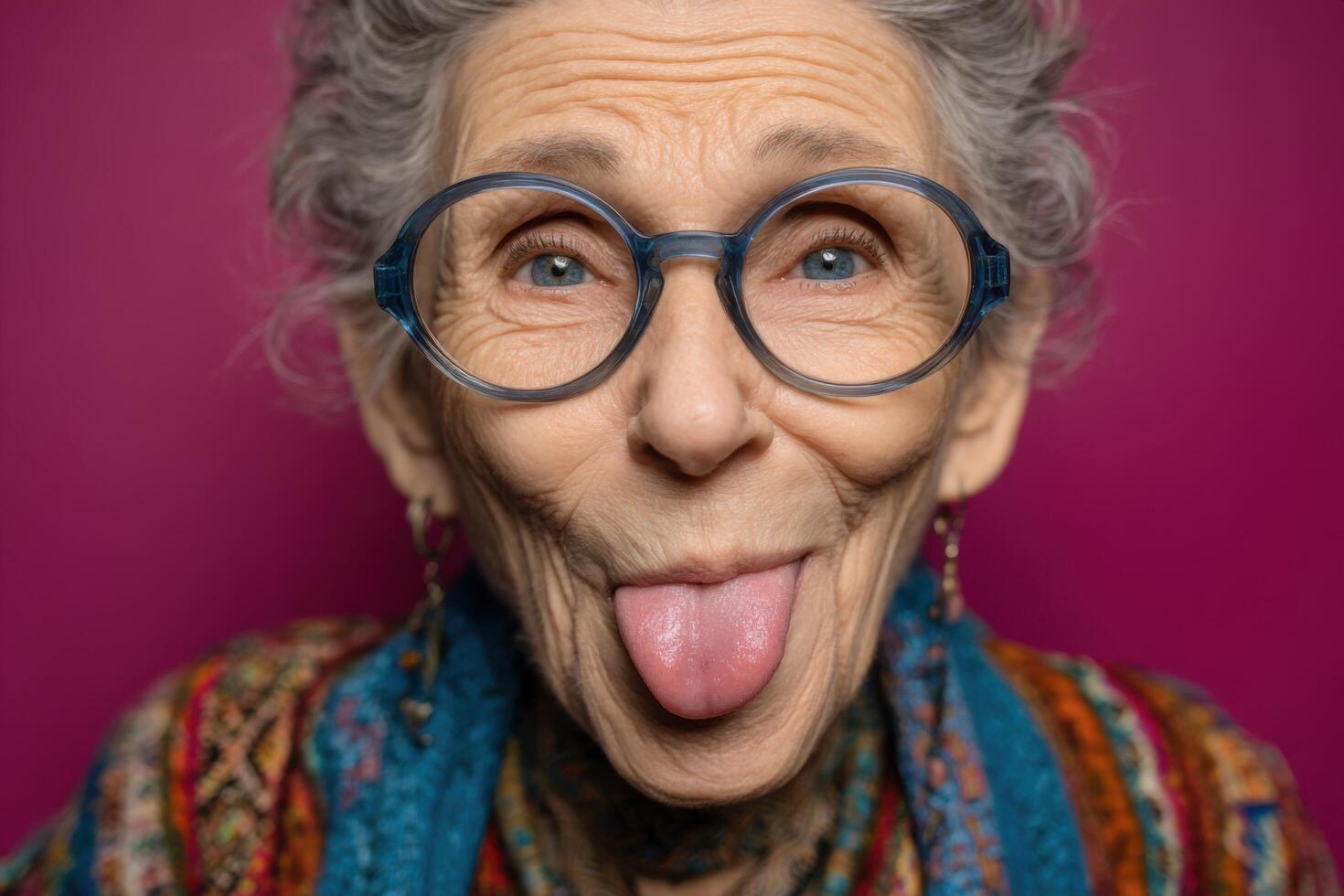 An old woman with glasses sticking out her tongue photo