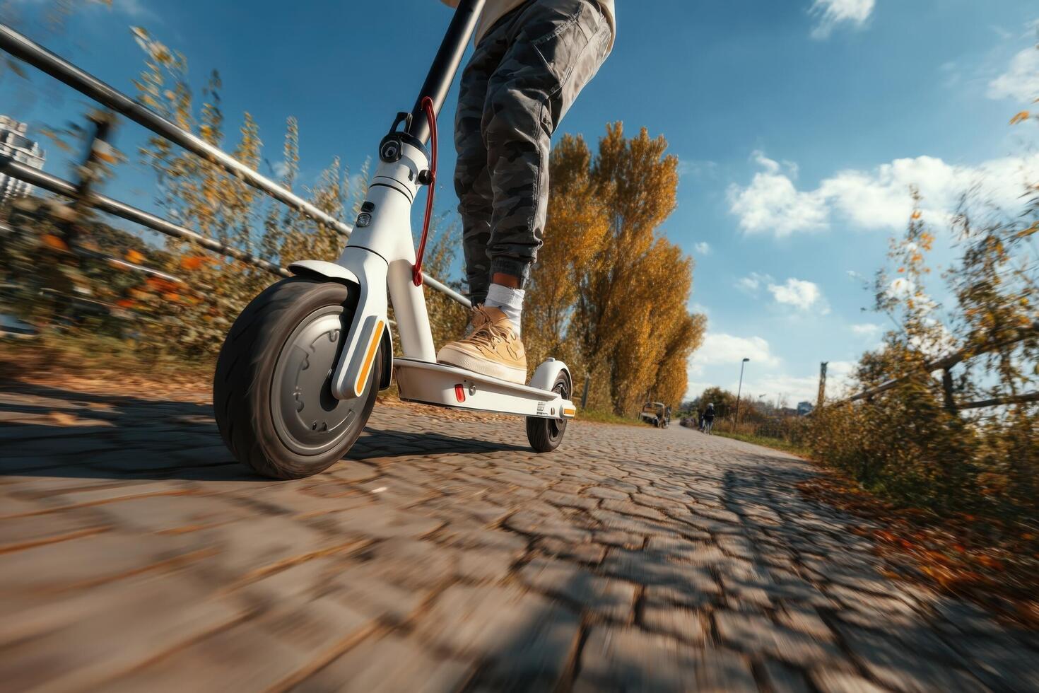 A person riding an electric scooter down a road photo
