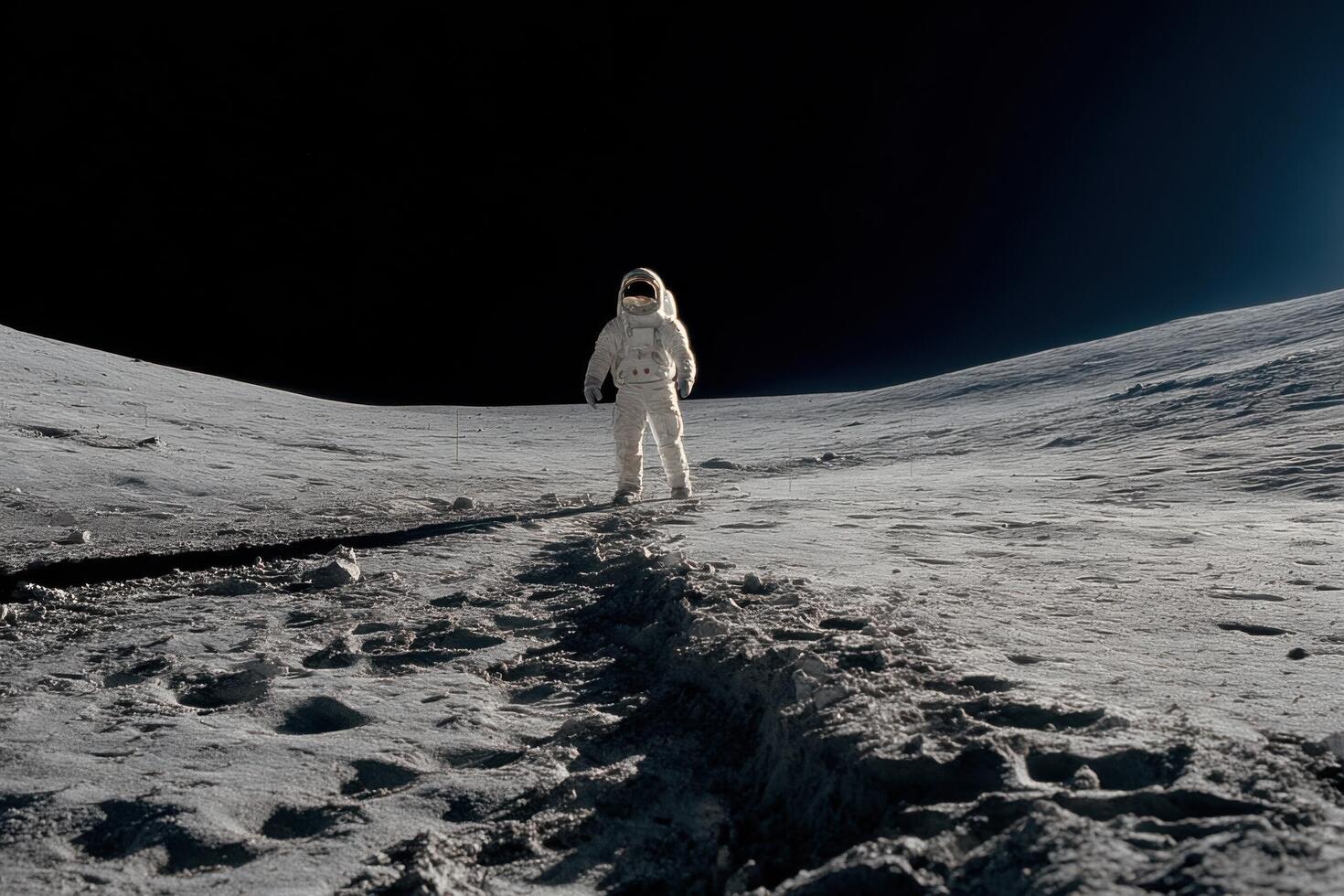 An astronaut standing on the moon with the sun behind him photo