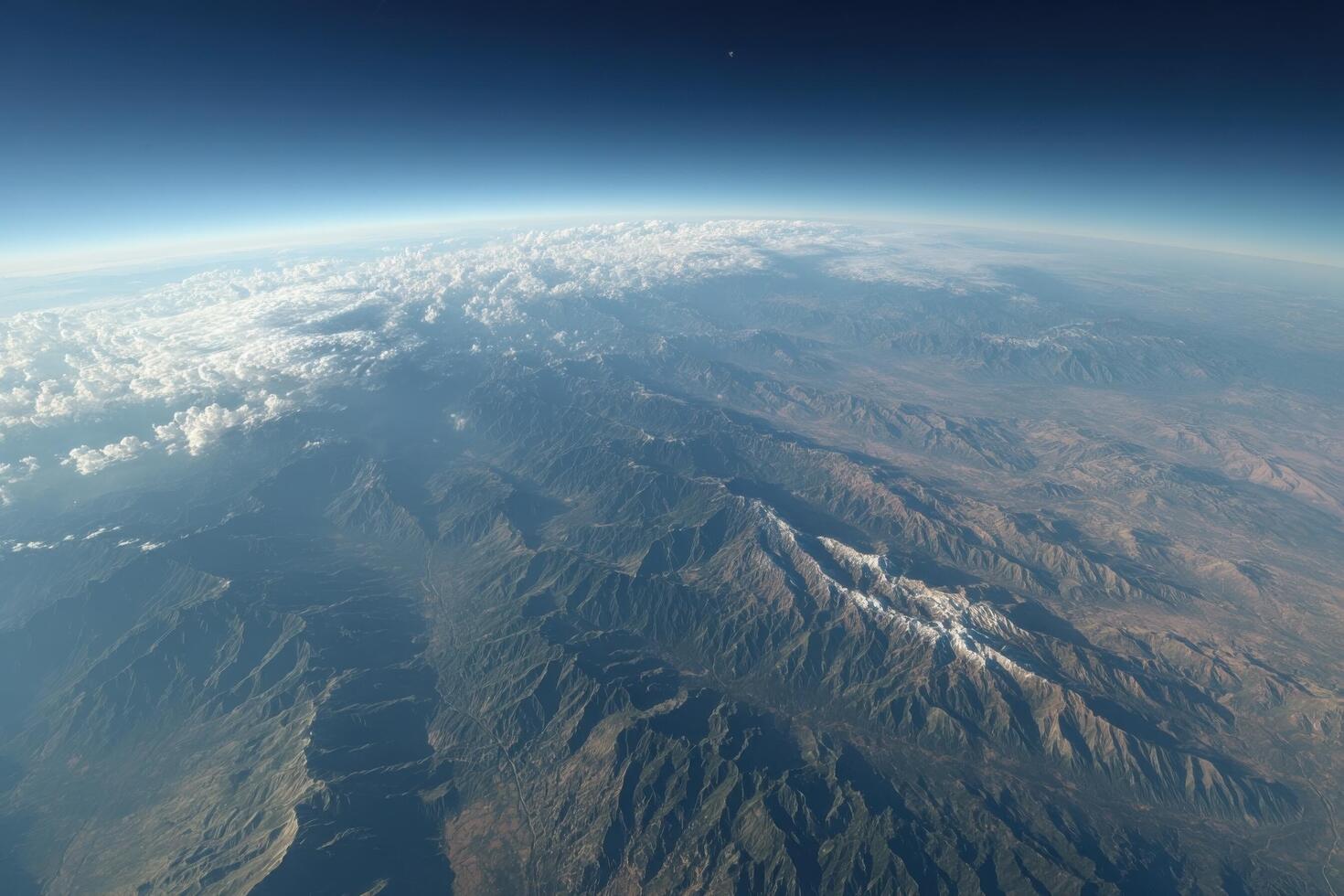 An aerial view of the mountains and clouds photo