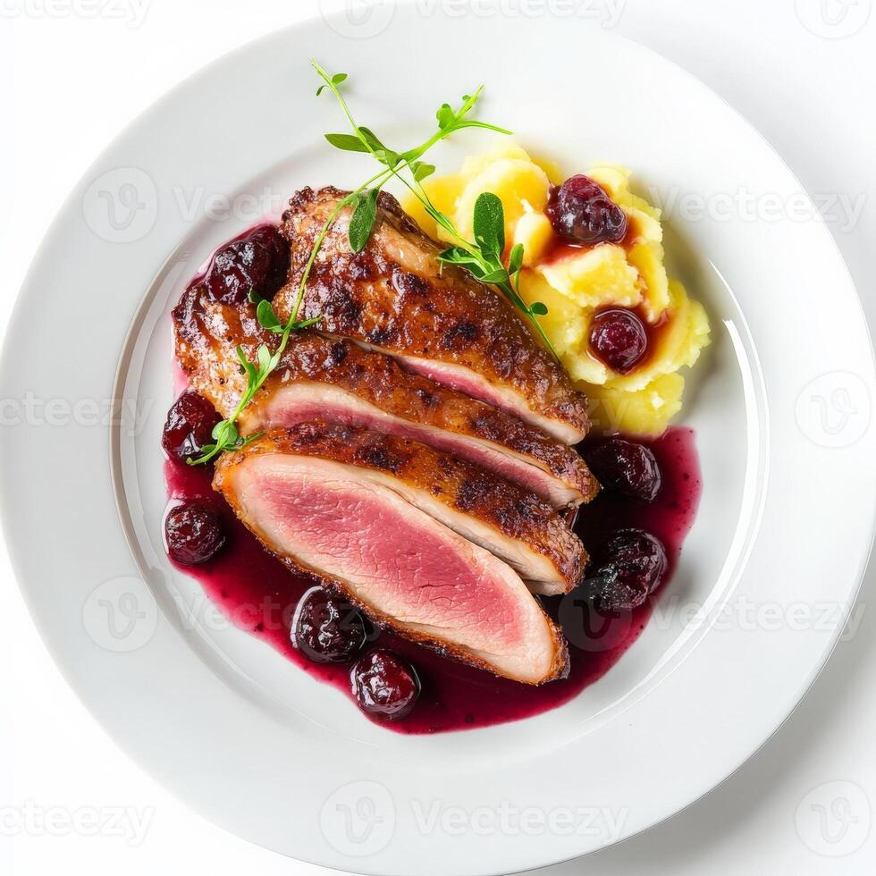 A plate of magret de canard, duck breast, cooked to medium-rare, with crispy skin and tender meat, served with a cherry sauce and a side of dauphinoise potatoes, showcasing the elegance of French cuisine and the mastery of duck preparation, arranged beaut photo