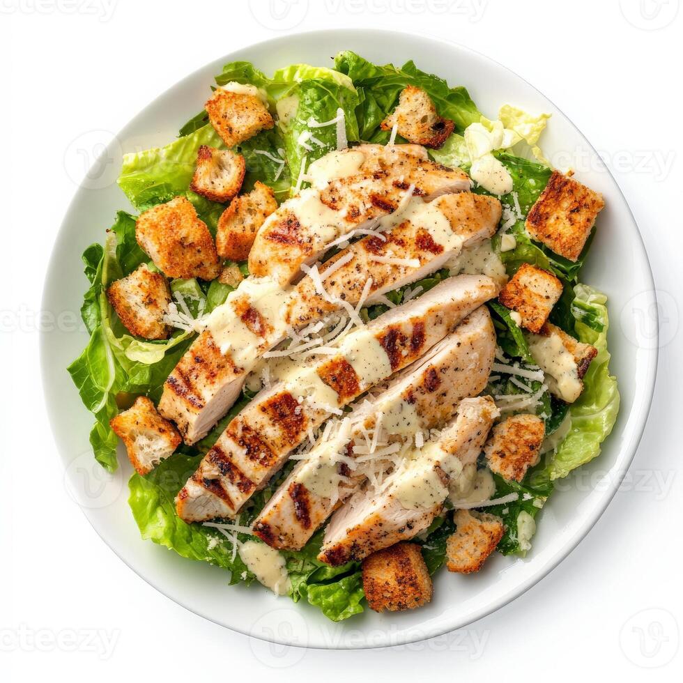 A freshly made Caesar salad with crisp romaine lettuce, crunchy croutons, shaved Parmesan cheese, and a creamy Caesar dressing. Topped with grilled chicken for extra protein and flavor. Isolated on clean white background photo