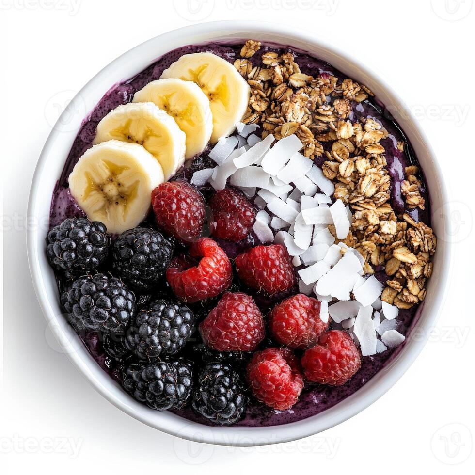 A vibrant bowl of acai topped with granola, sliced bananas, fresh berries, shredded coconut, and a drizzle of honey. A nutrient-packed, refreshing superfood breakfast. Isolated on clean white background photo